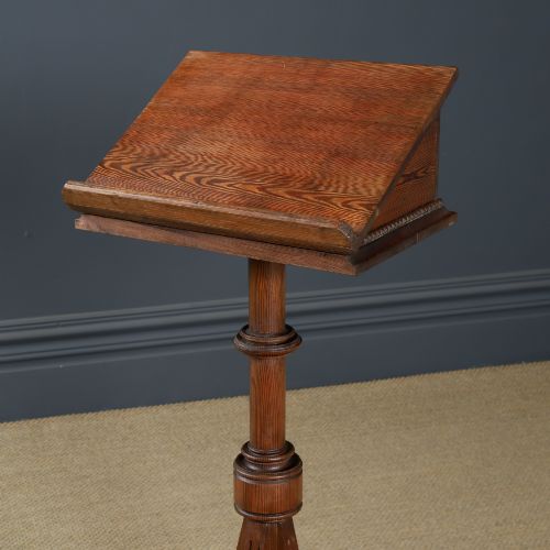 fig 1. An antique Victorian pitch pine lectern featuring a slanted book rest, turned central column, and a Gothic-style pedestal base.
