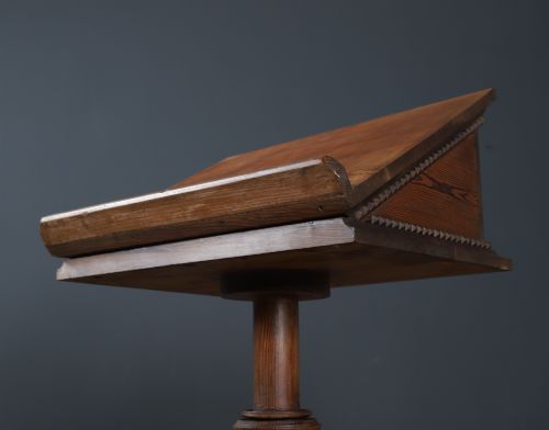 fig 2. An antique Victorian pitch pine lectern featuring a slanted book rest, turned central column, and a Gothic-style pedestal base.