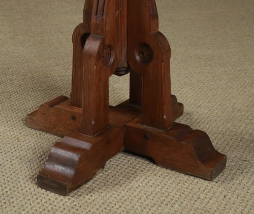 fig 4. An antique Victorian pitch pine lectern featuring a slanted book rest, turned central column, and a Gothic-style pedestal base.