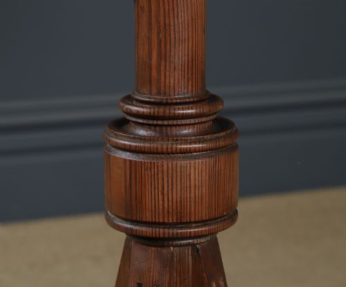 fig 6. An antique Victorian pitch pine lectern featuring a slanted book rest, turned central column, and a Gothic-style pedestal base.
