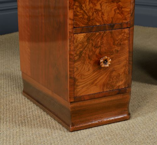fig 2. A pair of narrow Art Deco burr walnut bedside cabinets featuring two drawers with carved circular handles and a low back ledge.