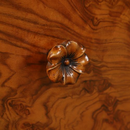 fig 3. A pair of narrow Art Deco burr walnut bedside cabinets featuring two drawers with carved circular handles and a low back ledge.
