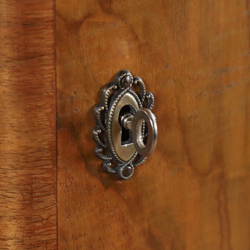 fig 3. An Art Deco walnut two door wardrobe featuring a bow front design, carved wood handles, and figured timber grain.