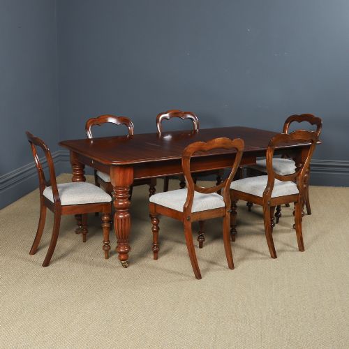 fig 1. A Victorian mahogany extending dining table with a rectangular top, rounded corners, and turned fluted legs set on brass castors.