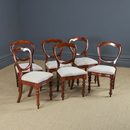 fig 1. A set of six Victorian mahogany dining chairs featuring open balloon-shaped backs, turned front legs, and neutral upholstered seats.