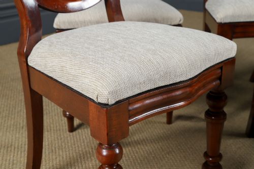 fig 5. A set of six Victorian mahogany dining chairs featuring open balloon-shaped backs, turned front legs, and neutral upholstered seats.