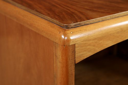 fig 4. A pair of Art Deco walnut bedside tables with an upper open compartment and a lower cupboard featuring a round green handle.