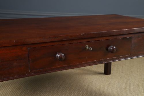 fig 2. An antique rectangular dark mahogany low coffee table featuring a single drawer with two turned handles and a brass keyhole.