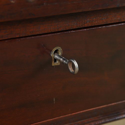 fig 3. An antique rectangular dark mahogany low coffee table featuring a single drawer with two turned handles and a brass keyhole.