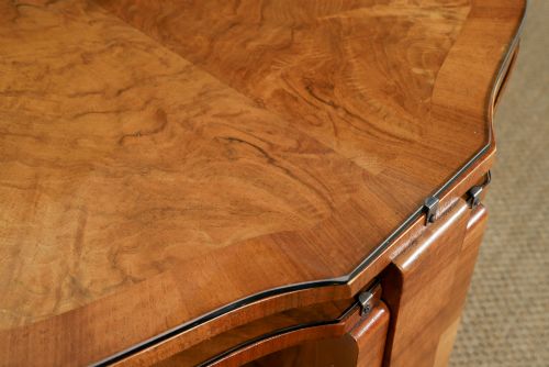 fig 5. An Art Deco round walnut nest of five occasional tables featuring four quadrant side tables fitted beneath a central coffee table top.
