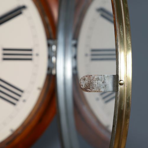 fig 8. An antique Smiths circular wall clock with a turned mahogany surround, off-white dial plate, black Roman numerals, and brass bezel.