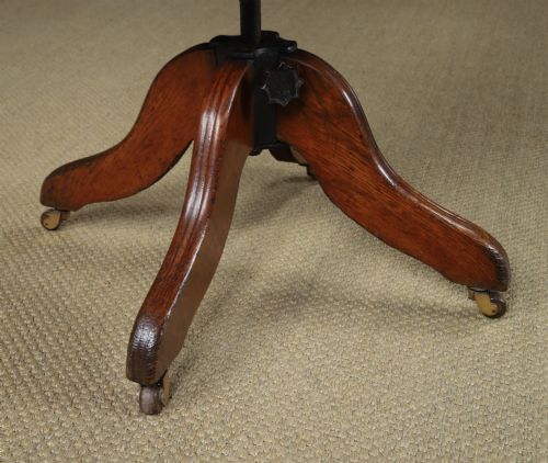 fig 3. An Edwardian oak revolving desk armchair featuring a carved pierced back splat, green leather upholstered seat with close studding, and a four-point swivel base on brass castors.