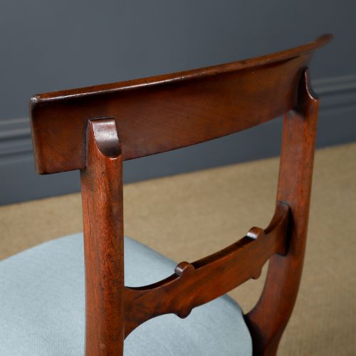 fig 9. A set of six antique mahogany dining chairs featuring curved top rails, carved horizontal splats, fluted turned front legs, and light blue upholstered seats.