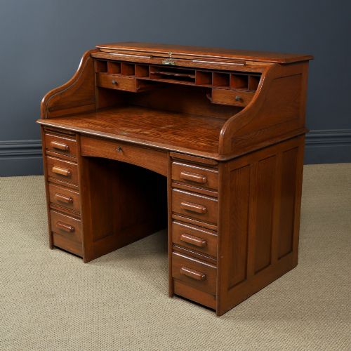fig 8. An Edwardian warm brown oak twin-pedestal rolltop desk featuring a flexible slatted wooden tambour shutter open to reveal internal pigeonholes above nine drawers with wooden cup handles.