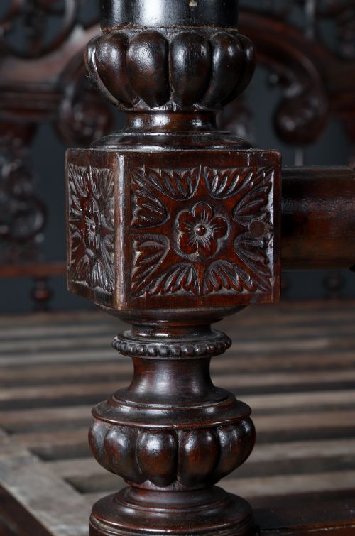 fig 4. An Anglo-Indian mahogany four poster bed featuring carved turned posts, an ornate headboard, and a spindle footboard.