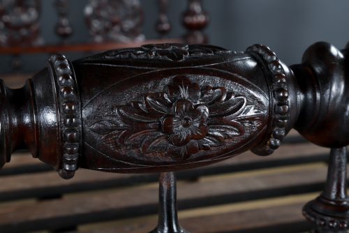fig 6. An Anglo-Indian mahogany four poster bed featuring carved turned posts, an ornate headboard, and a spindle footboard.