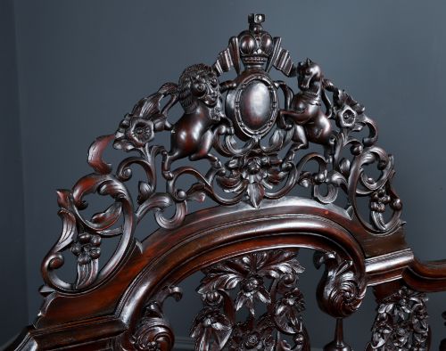 fig 10. An Anglo-Indian mahogany four poster bed featuring carved turned posts, an ornate headboard, and a spindle footboard.