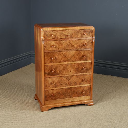 fig 1. An Art Deco chest of drawers in figured burr walnut featuring six graduated drawers with turned wooden handles and carved shoulder details.