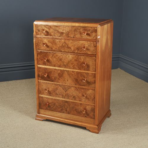 fig 7. An Art Deco chest of drawers in figured burr walnut featuring six graduated drawers with turned wooden handles and carved shoulder details.
