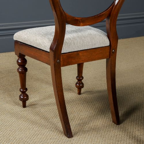 fig 5. A pair of mid-nineteenth century Victorian mahogany dining chairs featuring balloon back frames, turned front legs, and neutral fabric upholstered seats.