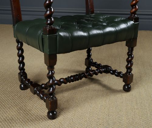 fig 2. An antique 17th-century style dark oak armchair featuring deep-buttoned green leather upholstery, brass stud trim, and barley-twist turned legs and stretchers.