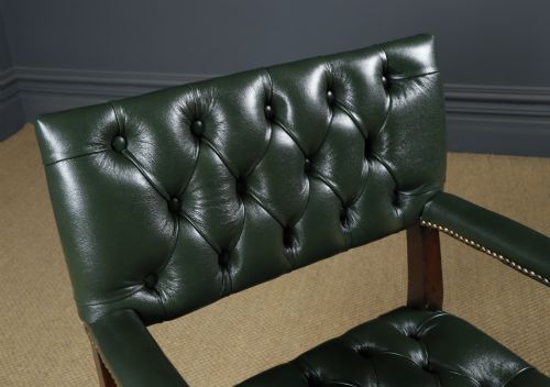 fig 5. An antique 17th-century style dark oak armchair featuring deep-buttoned green leather upholstery, brass stud trim, and barley-twist turned legs and stretchers.