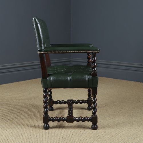 fig 9. An antique 17th-century style dark oak armchair featuring deep-buttoned green leather upholstery, brass stud trim, and barley-twist turned legs and stretchers.