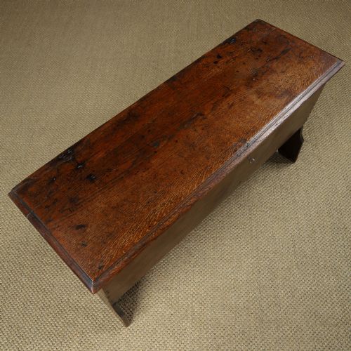 fig 3. A rectangular dark brown oak six-plank coffer featuring V-cut side legs and iron keyhole escutcheon detail.