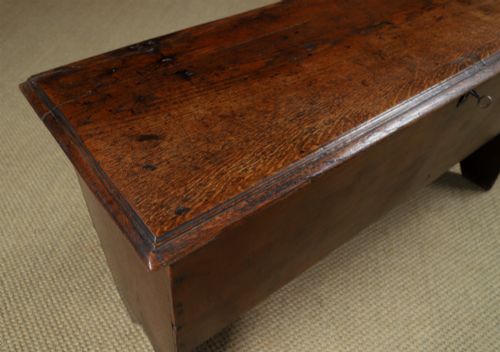 fig 5. A rectangular dark brown oak six-plank coffer featuring V-cut side legs and iron keyhole escutcheon detail.