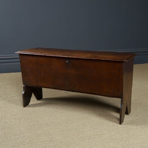 fig 6. A rectangular dark brown oak six-plank coffer featuring V-cut side legs and iron keyhole escutcheon detail.