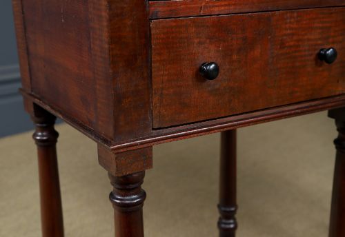 fig 3. A pair of tall Victorian mahogany bedside tables featuring two small drawers with black knobs, turned legs, and a concave lower shelf.
