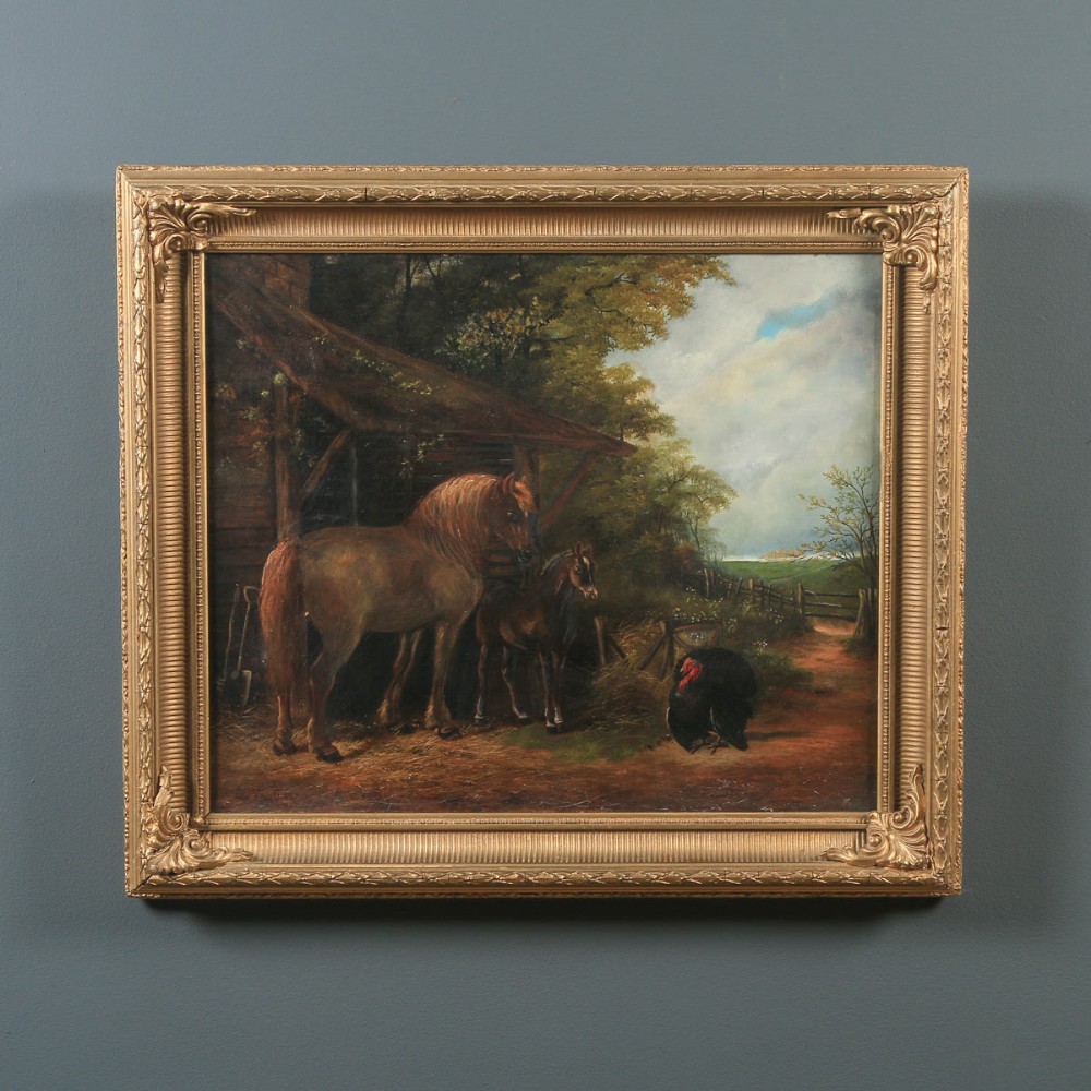 A Victorian oil painting depicting a horse, foal, and turkey outside a wooden barn structure housed in a gilded frame.