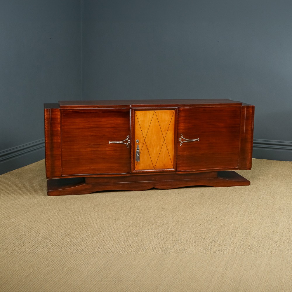 An Art Deco mahogany sideboard featuring a serpentine front, central diamond parquetry door in maple, and streamlined metal handles.