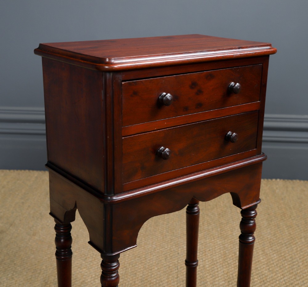 A pair of tall Victorian mahogany bedside tables featuring two drawers, turned legs, and cross stretchers. View XX