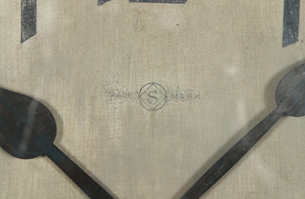 A large circular antique wall clock featuring a dark mahogany wooden surround, an off-white dial with bold black Arabic numerals, and twin winding keyholes. View II