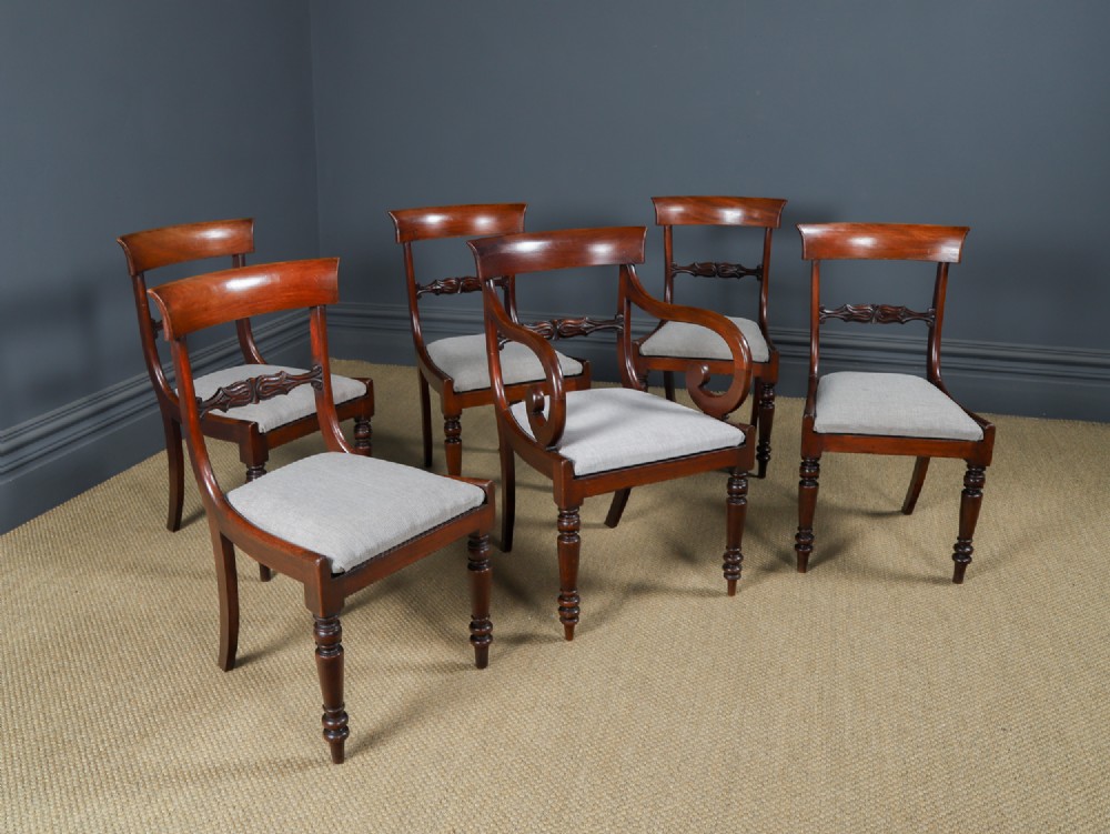 A set of six mahogany Regency dining chairs featuring carved back rails, turned front legs, and light-coloured upholstered seats. View II