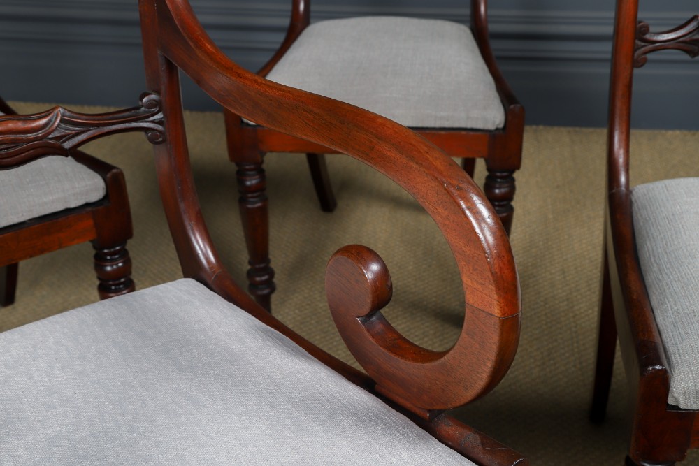 A set of six mahogany Regency dining chairs featuring carved back rails, turned front legs, and light-coloured upholstered seats. View V