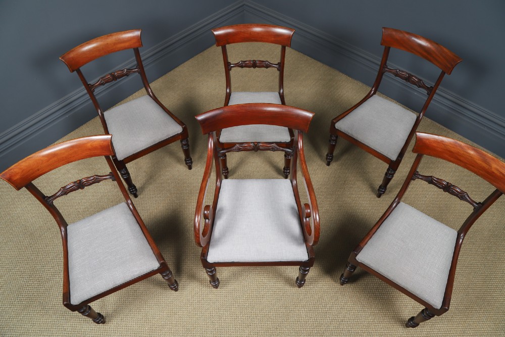 A set of six mahogany Regency dining chairs featuring carved back rails, turned front legs, and light-coloured upholstered seats. View VII