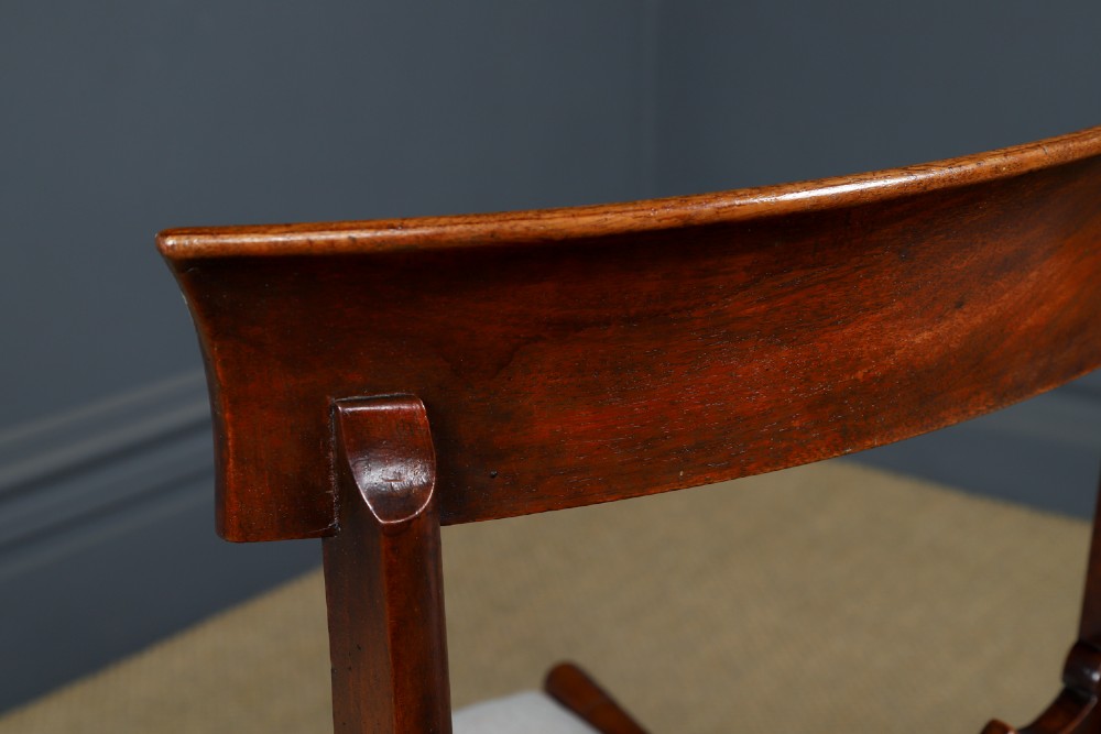 A set of six mahogany Regency dining chairs featuring carved back rails, turned front legs, and light-coloured upholstered seats. View X