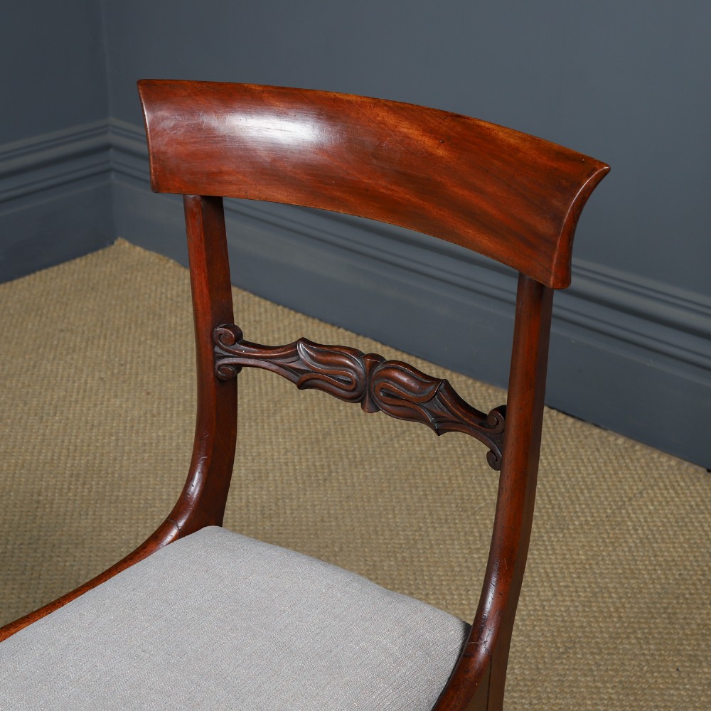 A set of six mahogany Regency dining chairs featuring carved back rails, turned front legs, and light-coloured upholstered seats. View XI