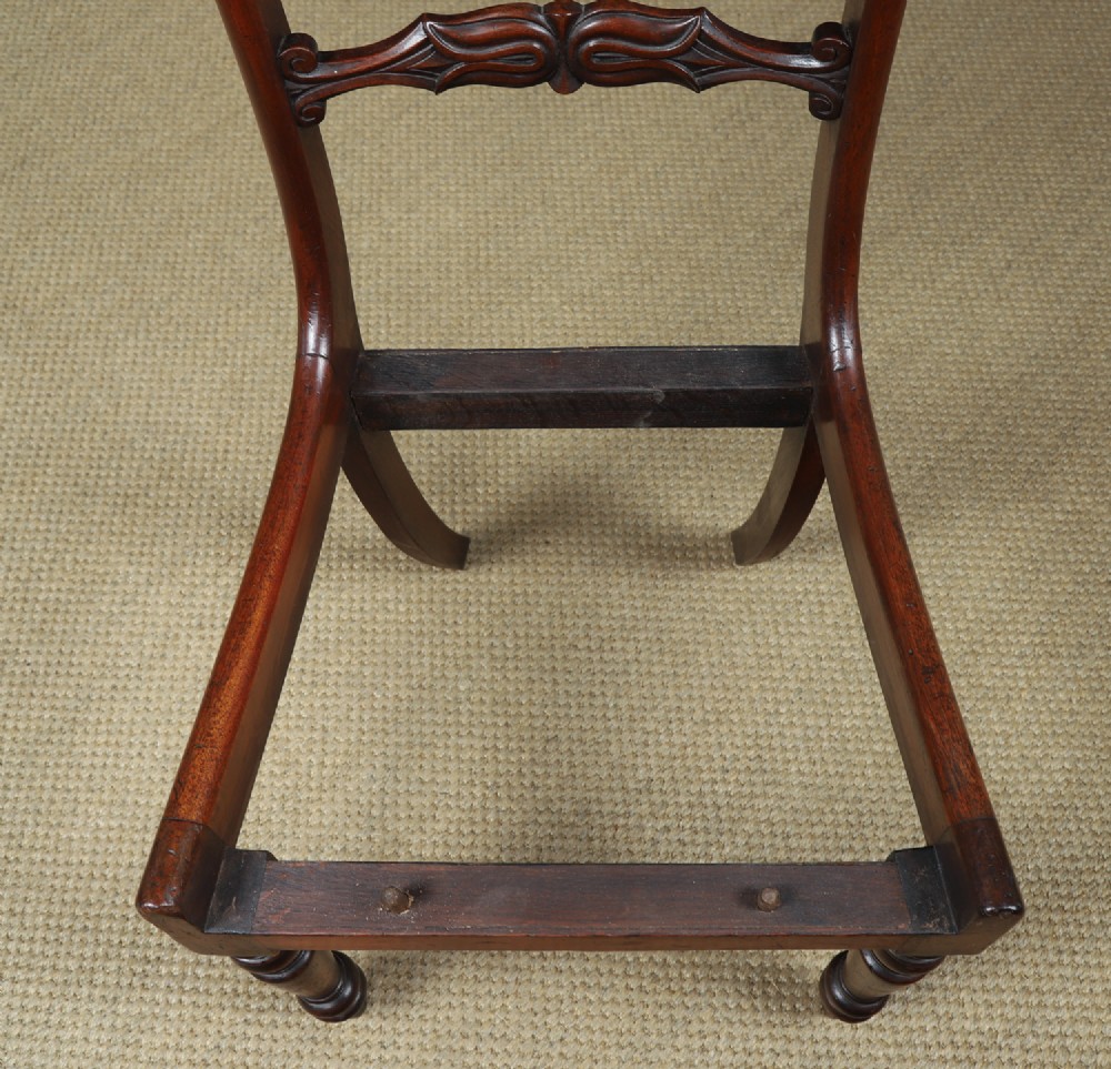 A set of six mahogany Regency dining chairs featuring carved back rails, turned front legs, and light-coloured upholstered seats. View XIV