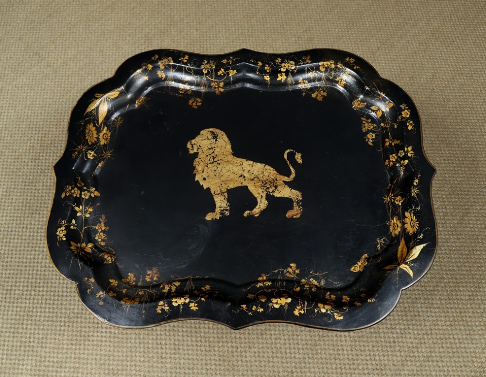 An ebonised Victorian papier-mache tray table featuring gilt Chinoiserie decoration and a lion motif, resting on a faux-bamboo base. View VI