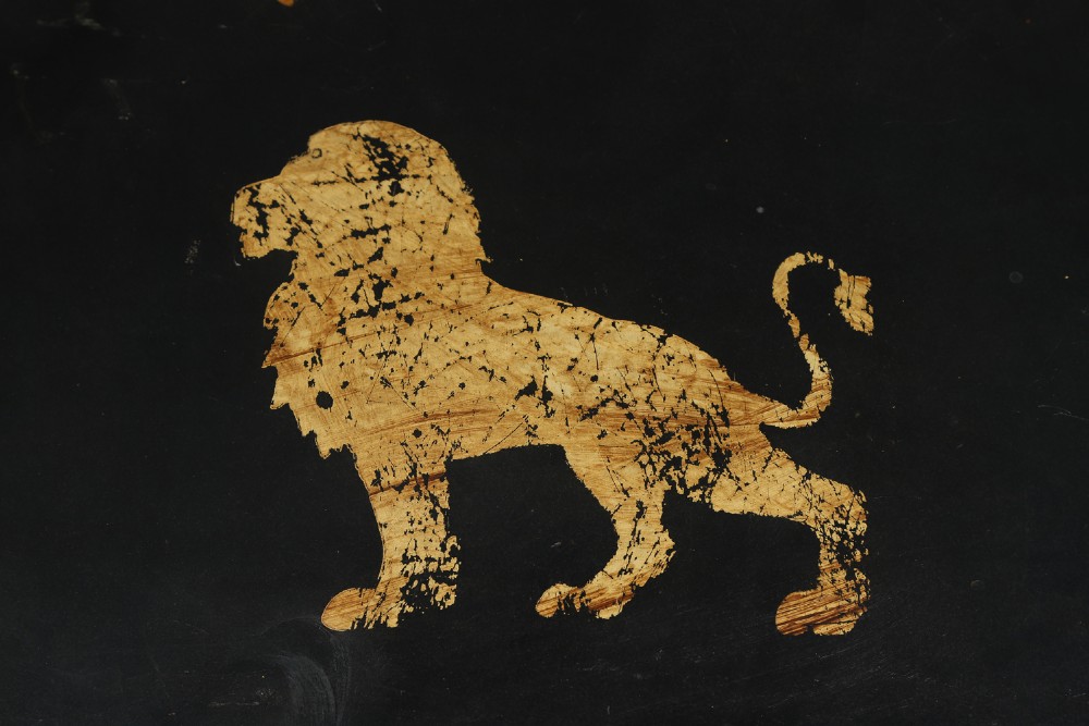 An ebonised Victorian papier-mache tray table featuring gilt Chinoiserie decoration and a lion motif, resting on a faux-bamboo base. View VII