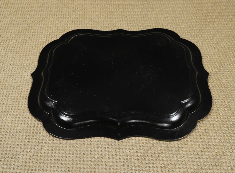 An ebonised Victorian papier-mache tray table featuring gilt Chinoiserie decoration and a lion motif, resting on a faux-bamboo base. View XIV