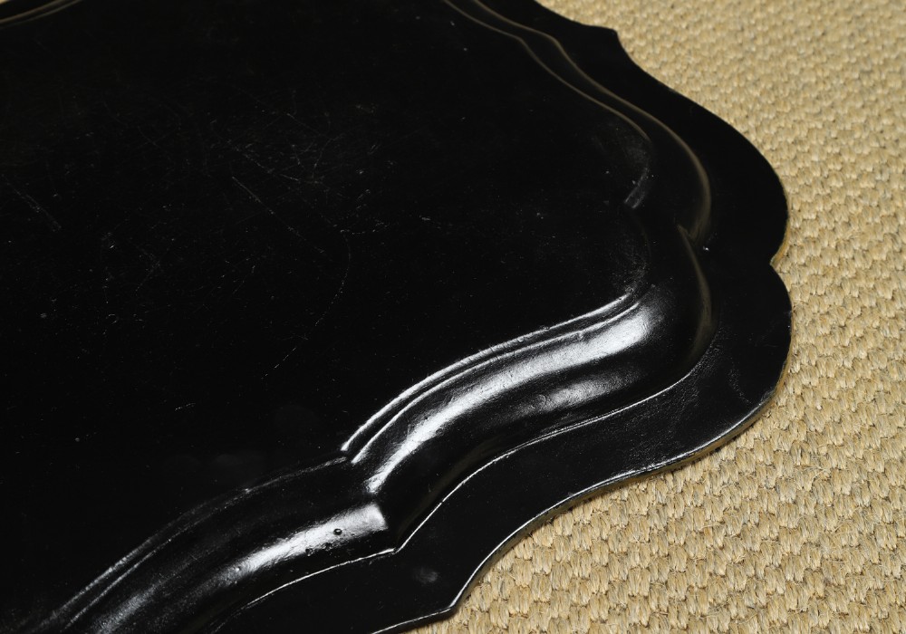 An ebonised Victorian papier-mache tray table featuring gilt Chinoiserie decoration and a lion motif, resting on a faux-bamboo base. View XV