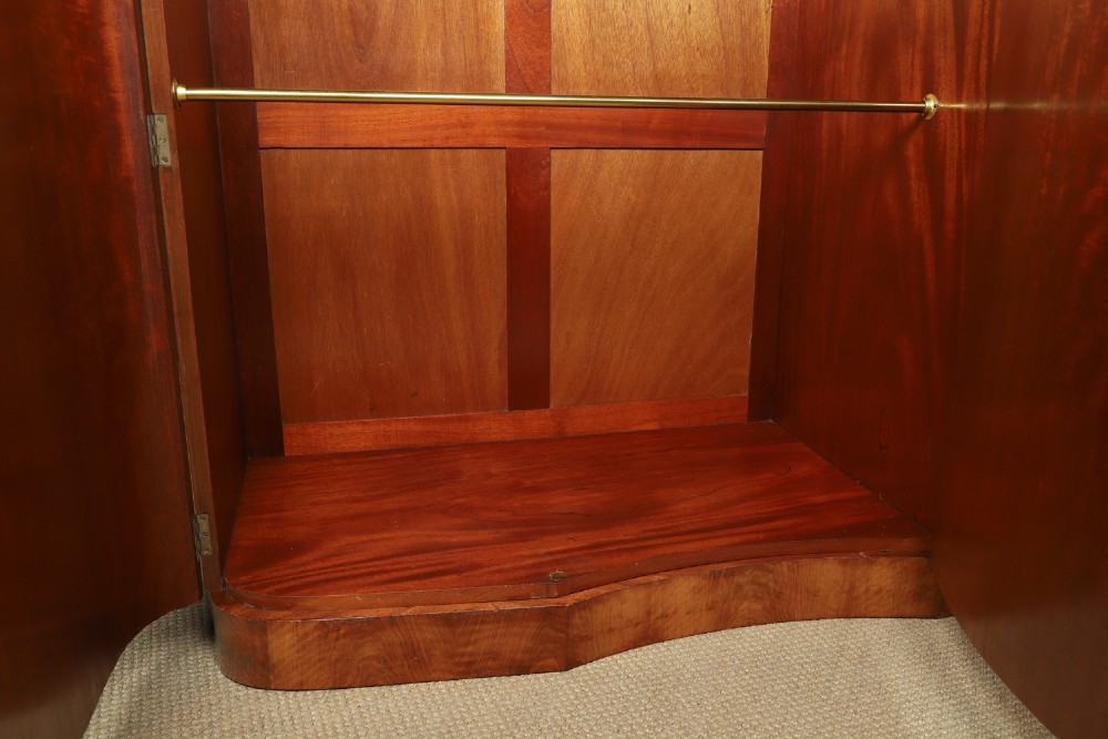 An English Art Deco triple-door wardrobe crafted from figured burr walnut with curved sides and vertical handles. View IX