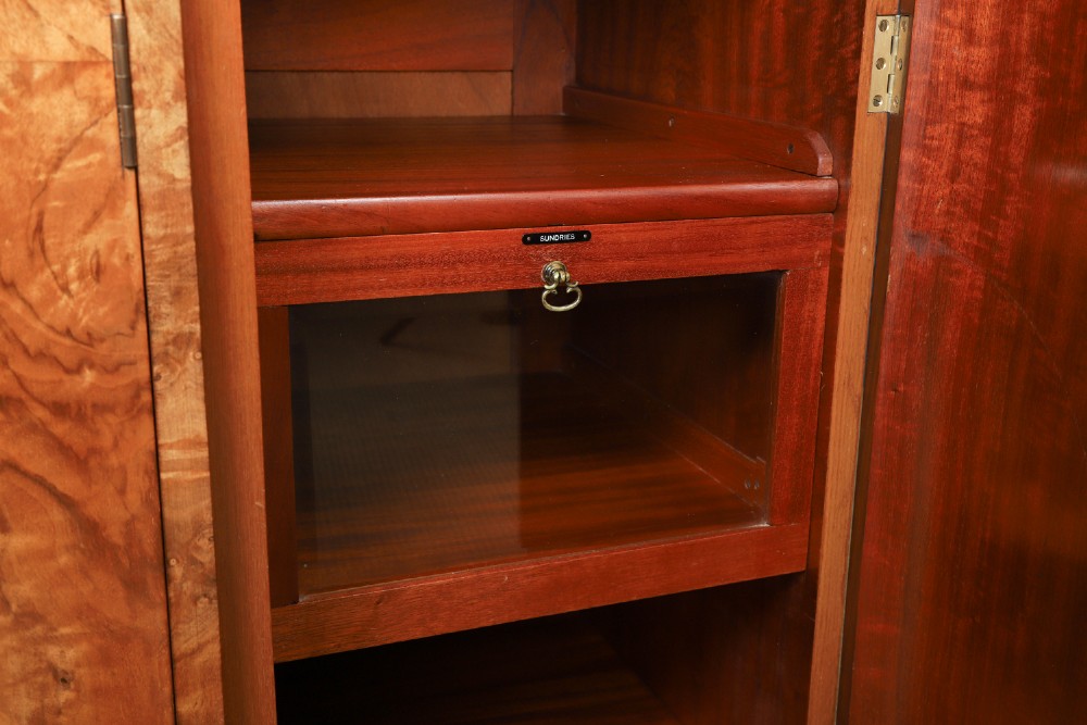 An English Art Deco triple-door wardrobe crafted from figured burr walnut with curved sides and vertical handles. View XII