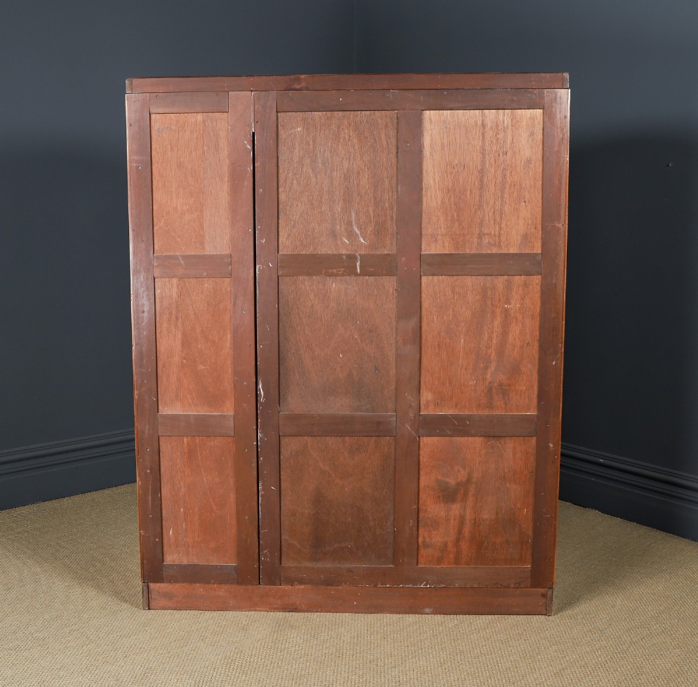 An English Art Deco triple-door wardrobe crafted from figured burr walnut with curved sides and vertical handles. View XIV