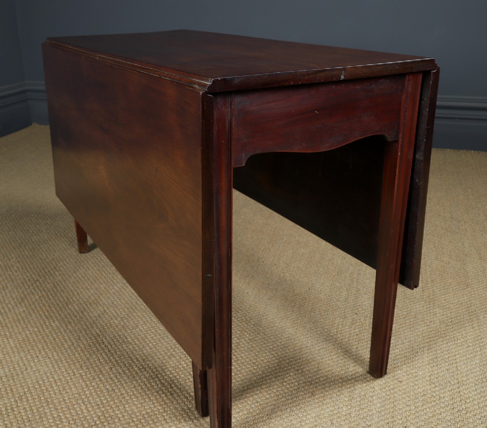 A Georgian mahogany drop-leaf dining table shown fully extended with rectangular flaps, a shaped apron, and straight square legs. View VIII