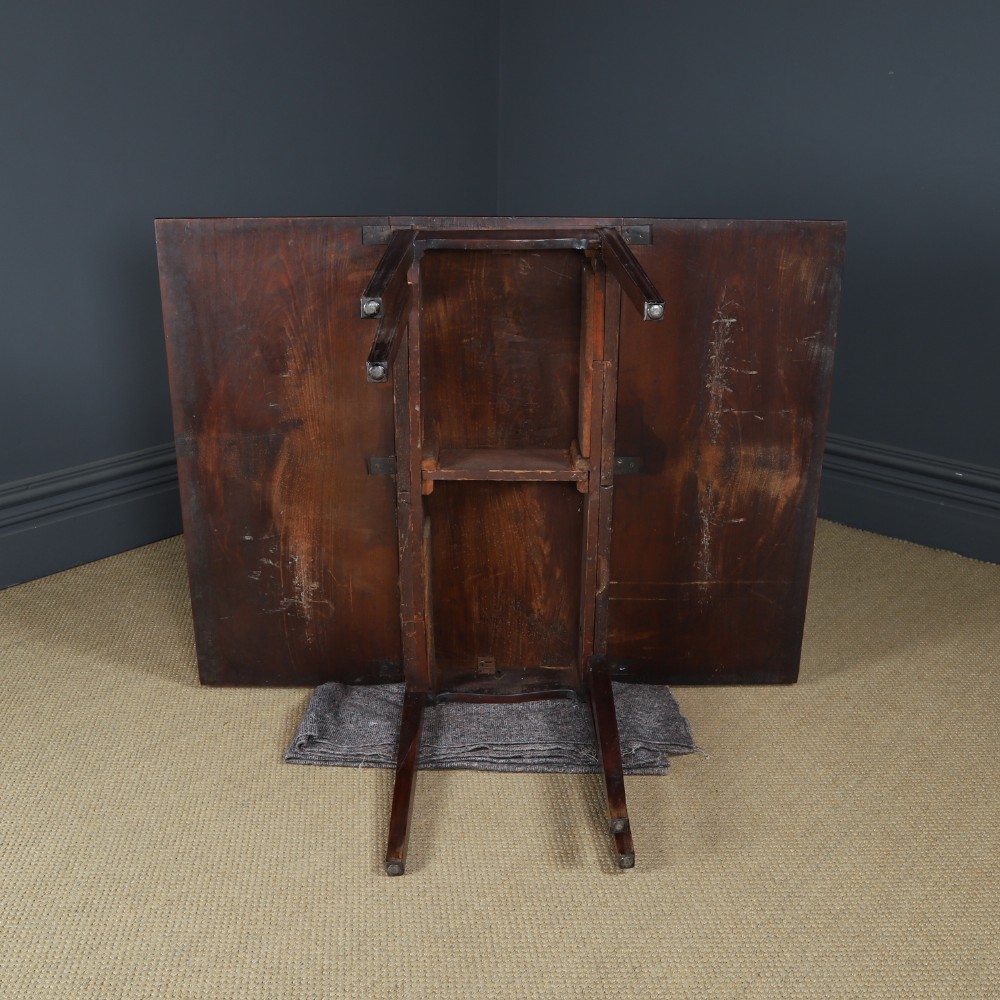 A Georgian mahogany drop-leaf dining table shown fully extended with rectangular flaps, a shaped apron, and straight square legs. View XIII